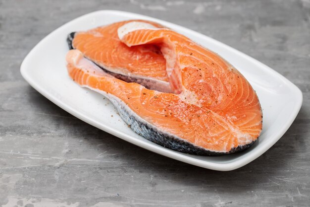 Fresh raw salmon with salt on the dish