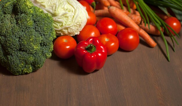 Fresh raw set of vegetables on wooden table