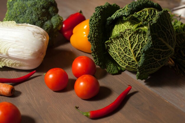 Fresh raw set of vegetables on wooden table