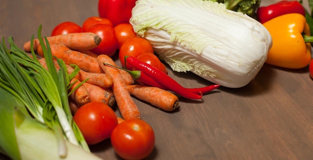 Fresh raw set of vegetables on wooden table