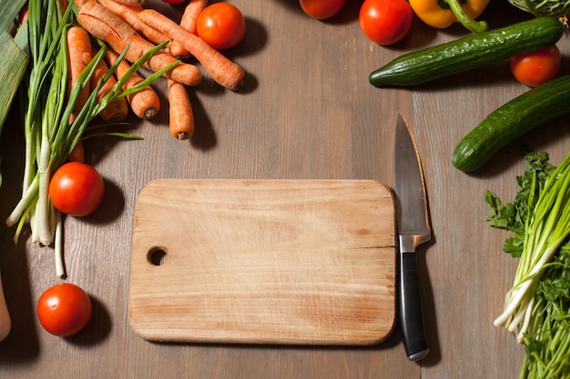 Fresh raw set of vegetables on wooden table