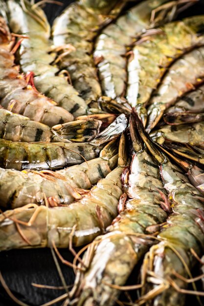 Fresh raw shrimp on a round stone board