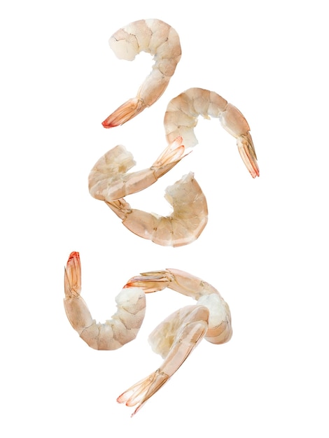 Fresh raw shrimps falling on white background