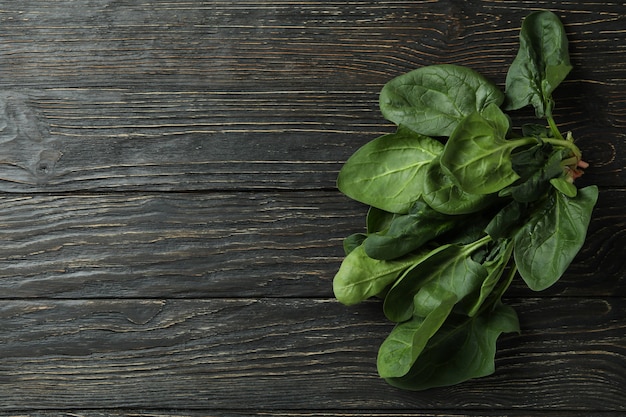 Fresh raw spinach on rustic wooden