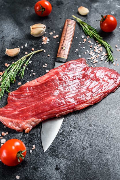 Fresh raw steak with spices on the table