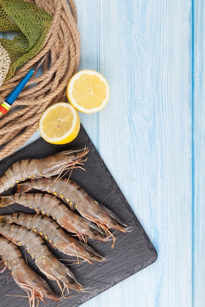 Fresh raw tiger prawns and fishing equipment