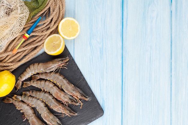 Fresh raw tiger prawns and fishing equipment