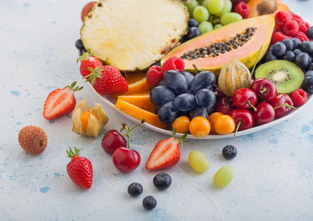 Fresh raw tropical fruits on a plate