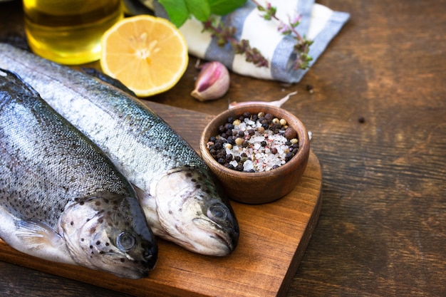 Fresh raw trout fish and pickle ingredients Cooking grilled fish preparation Copy space