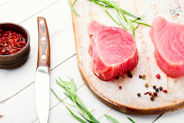 Fresh raw tuna steak on kitchen board