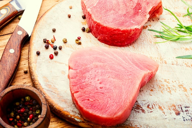 Fresh raw tuna steak on kitchen board