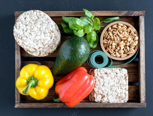 Fresh raw vegetable ingredients for healthy cooking or salad making with rustic wooden tray