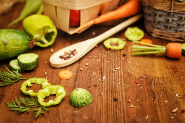 Fresh raw vegetables basket on a wooden board