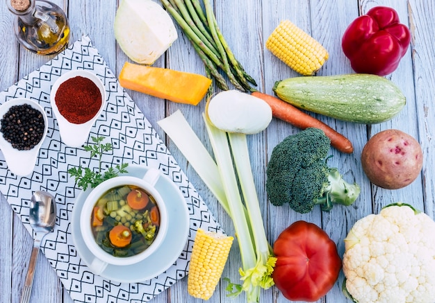 A fresh readytoeat home made vegetable soup Raw vegetables on the wooden table