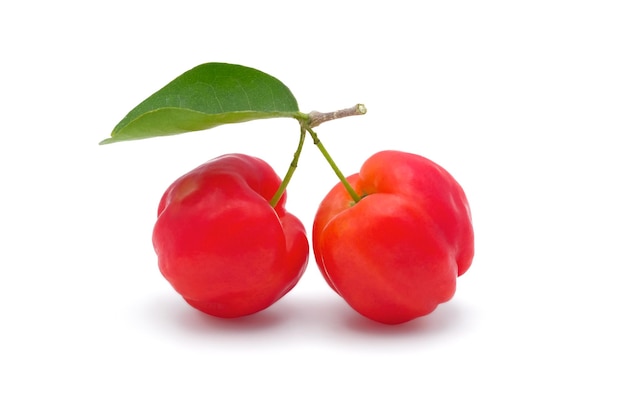 Fresh red acerola cherries with green leave isolated on white background