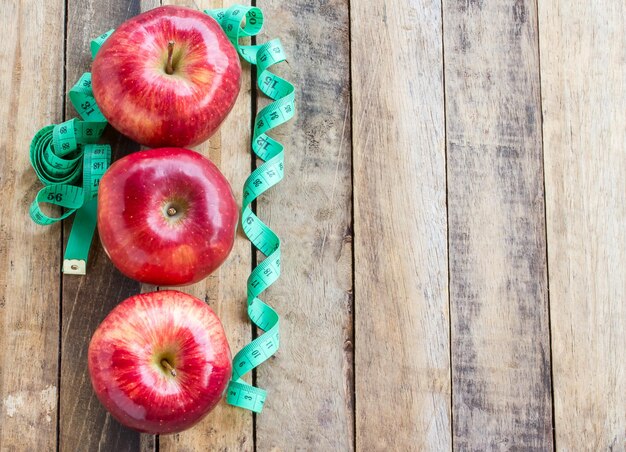 Fresh Red apple on wood table background Top view with copy space