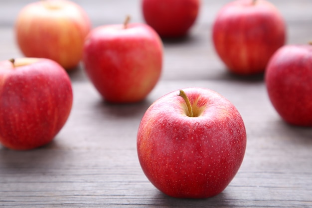 Fresh red apples on a grey wooden background