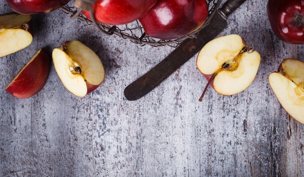 Fresh red apples in a metal basket on wooden background.Copy space.selective focus.