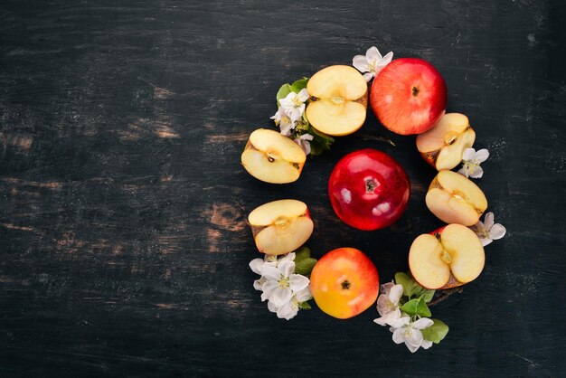 Photo fresh red apples with inflorescences and leaves on a wooden background top view copy space