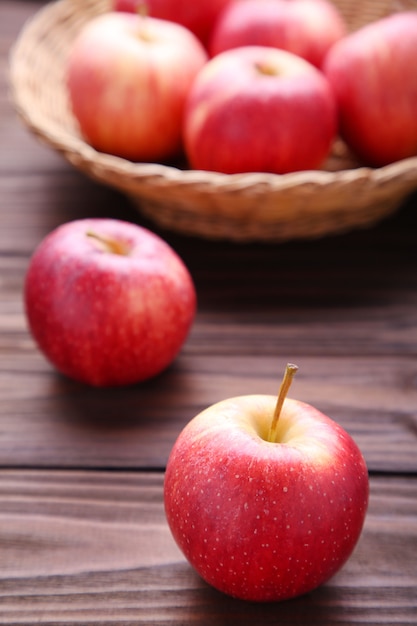 Fresh red apples on wooden background