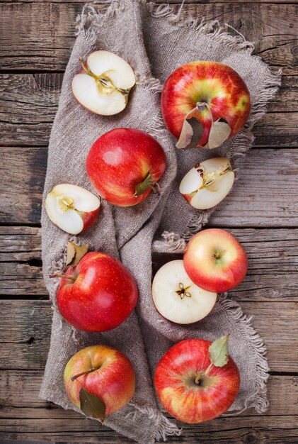 Fresh red apples on wooden surface