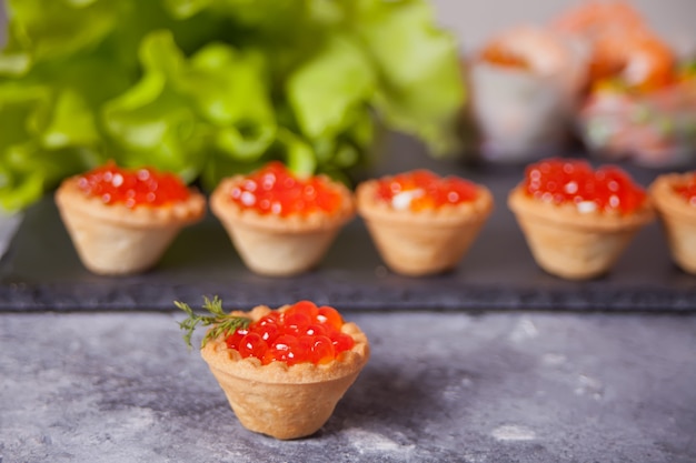 Fresh red caviar in tartlets. Delicatessen. Gourmet food