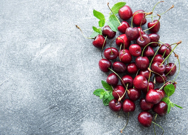 Fresh red cherries fruit on a concrete background