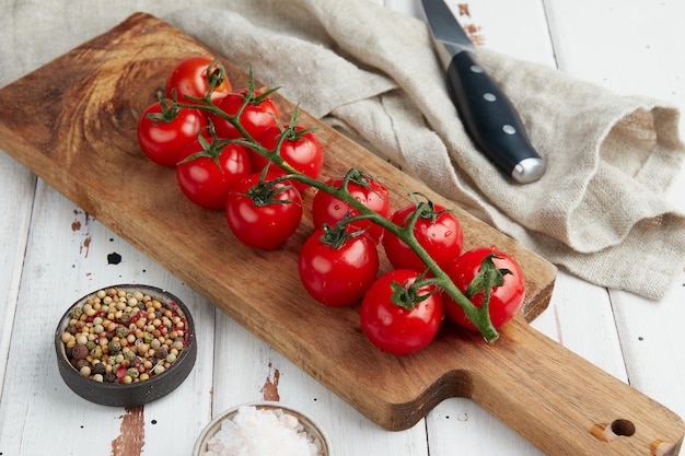 Fresh red cherry tomatoes on white wooden background