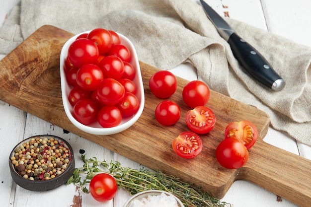 Fresh red cherry tomatoes on white wooden background