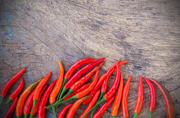 Fresh red chili on an old wooden background