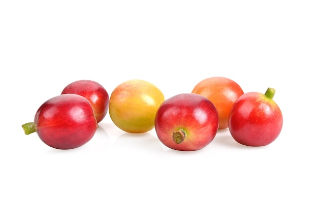 白い背景に分離された新鮮な赤いコーヒー豆の熟した、熟していない果実