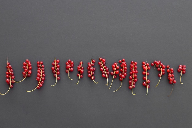 Fresh red currant berries on black background closeup