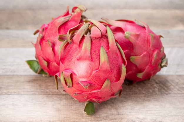 Fresh red dragon (pitaya) fruit juice in glass mug.