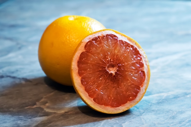 Fresh Red Grapefruit Slice On Table