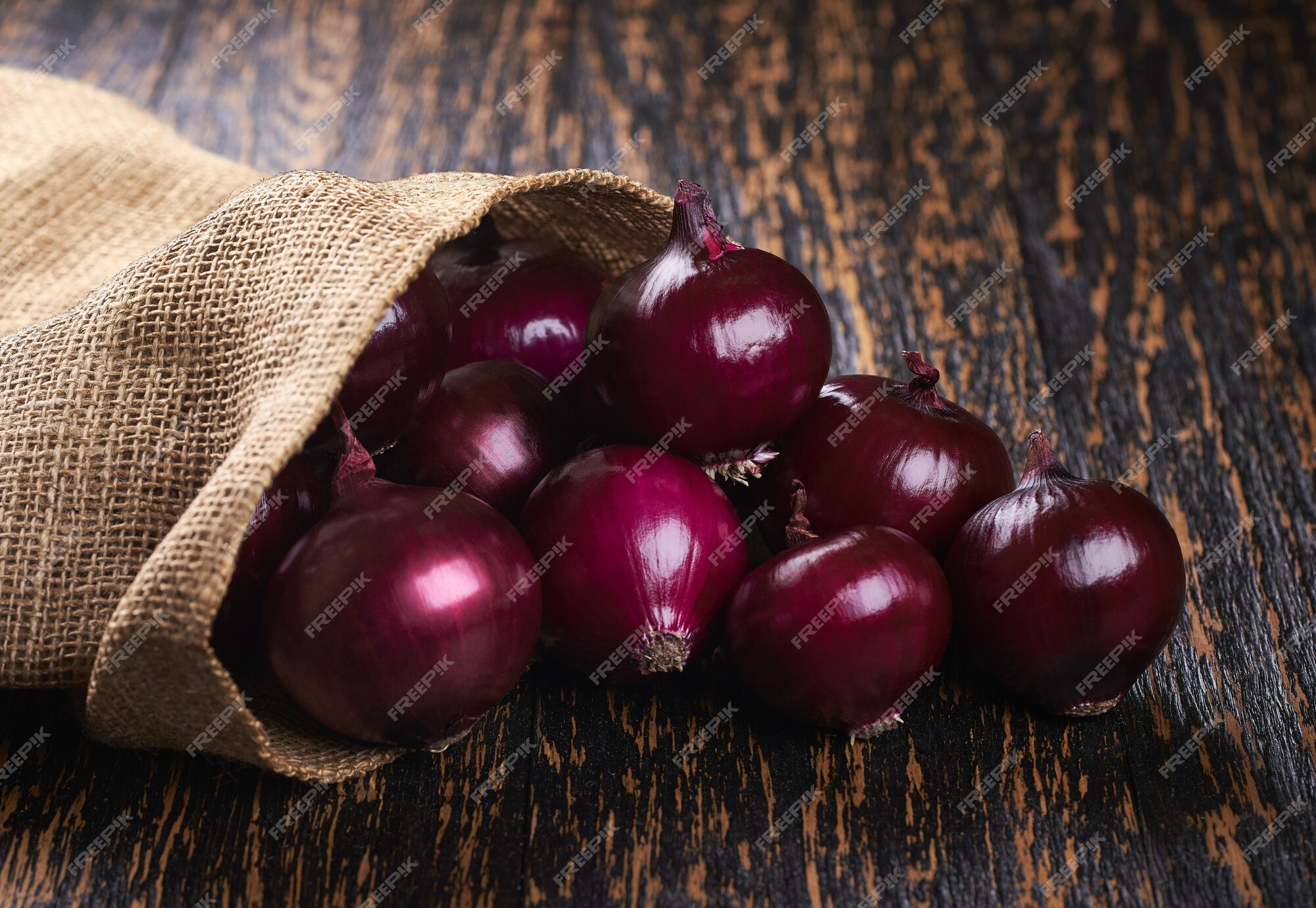 Premium Photo  Fresh red onions in bag on wooden