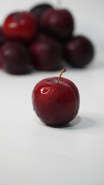 Fresh red plums on a white background
