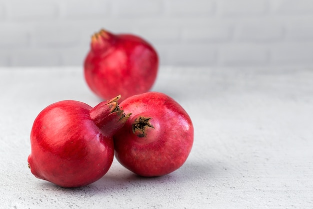 Fresh and red pomegranate on light background