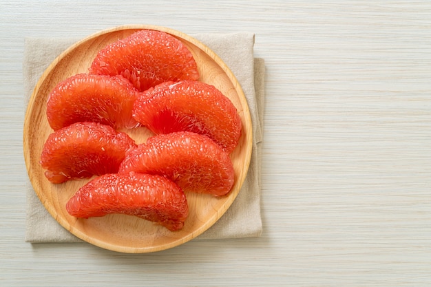 fresh red pomelo fruit or grapefruit on plate