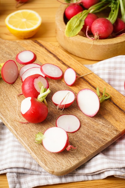 Fresh red radish slices on a wooden background closeup