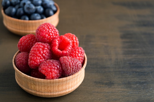 Fresh red raspberries on the table, close up.