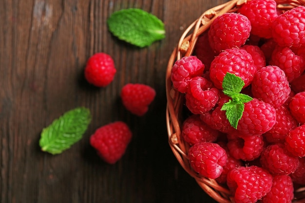 Fresh red raspberries on wooden table top view