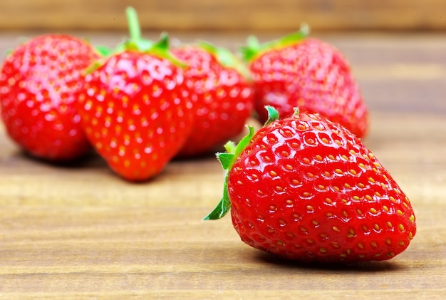 Fresh red ripe strawberries on wooden table.