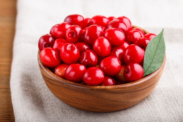 Fresh red sweet cherry in wooden bowl. side view.