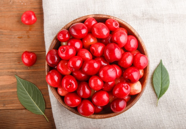 Fresh red sweet cherry in wooden bowl. top view.