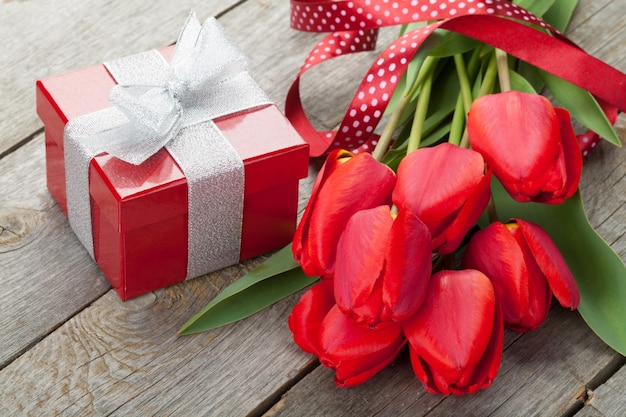 Fresh red tulips with gift box