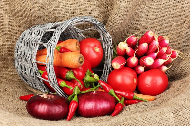 Fresh red vegetables on sackcloth background