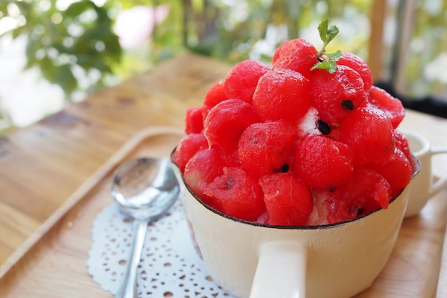 Fresh red watermelon bingsu on wooden table