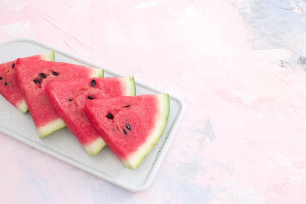 Fresh red watermelon slices Isolated pastel pink background