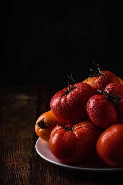 Fresh red and yellow tomatoes on plate