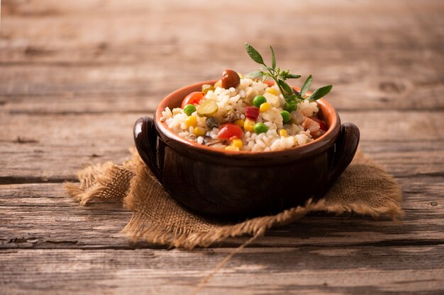 Fresh rice salad in a bowl close up shoot on wooden table